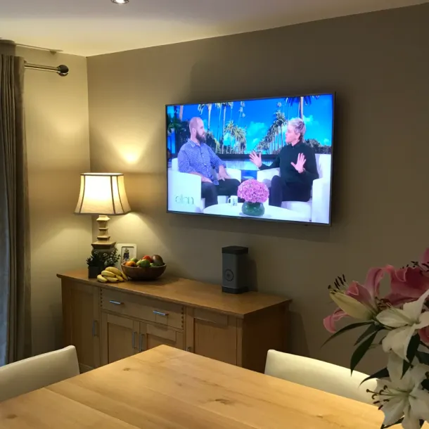 Seamless 4K TV wall installation with no visible wires or set-top boxes, integrated into a whole-home video distribution system.