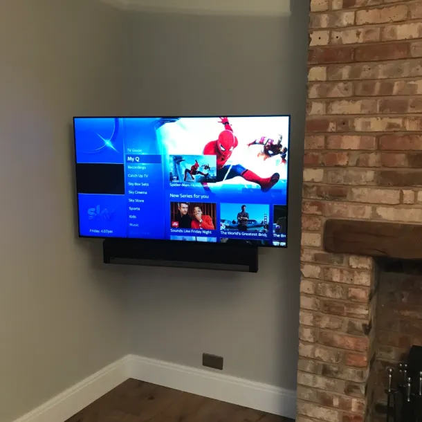 A clean, wall-mounted TV finish with all source equipment hidden 20 meters away in a dedicated media cupboard.
