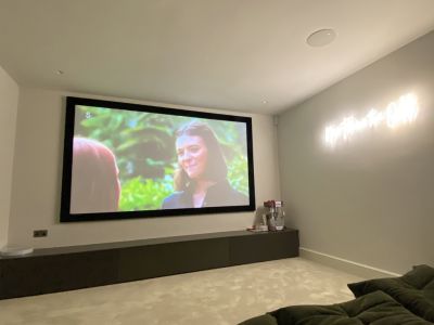 Cosy cinema room with projector screen and popcorn machine