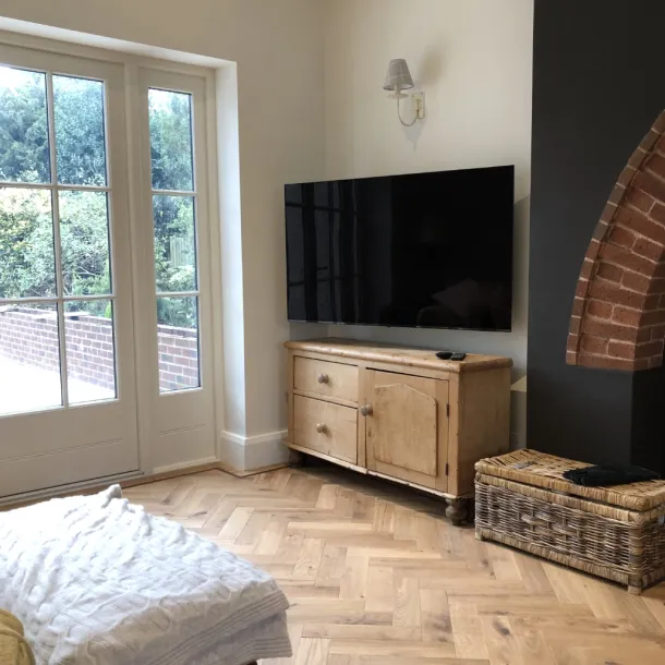 Custom media wall build featuring floating cabinetry and LED backlighting - Bowdon.