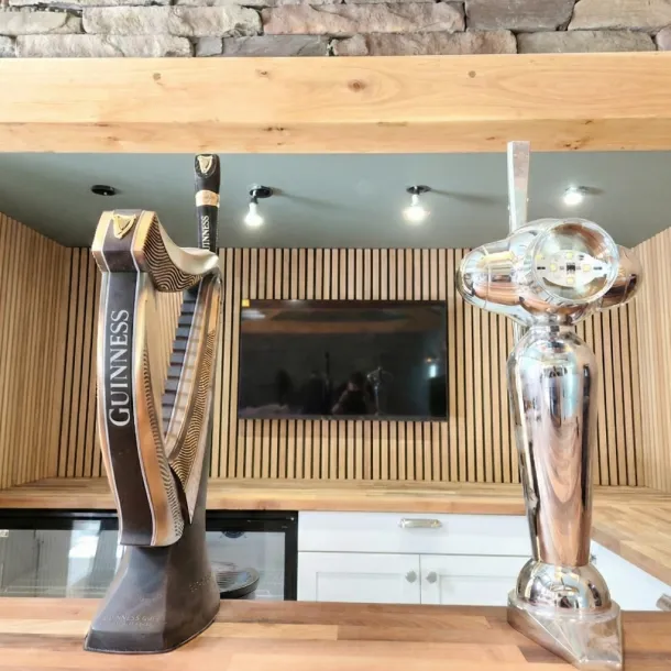 Designer media wall with minimalist storage and zero-visible wires - Urmston.